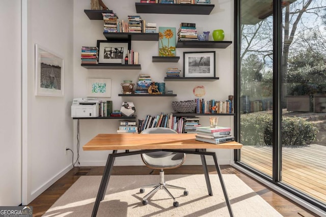 office area with baseboards and wood finished floors