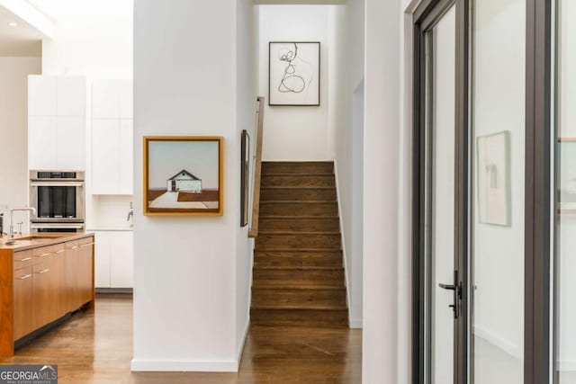 stairs featuring wood finished floors