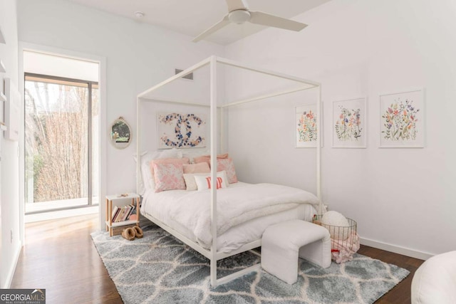 bedroom with a ceiling fan, baseboards, and wood finished floors