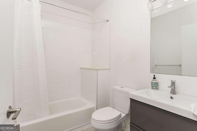 bathroom featuring shower / bath combo, vanity, and toilet