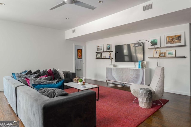 living room with baseboards, visible vents, ceiling fan, and wood finished floors