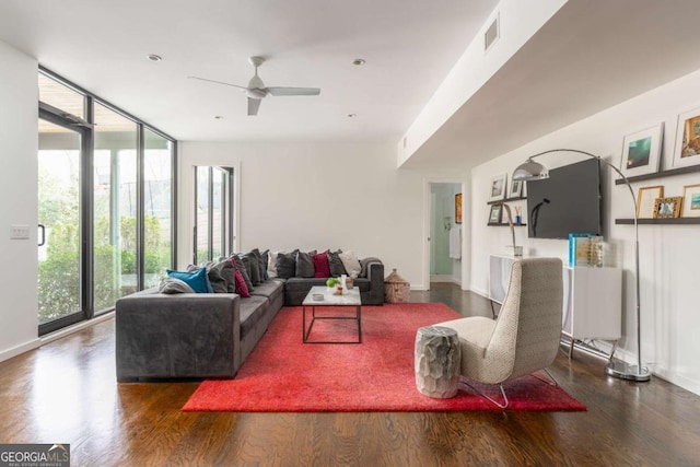 living area featuring floor to ceiling windows, visible vents, and wood finished floors