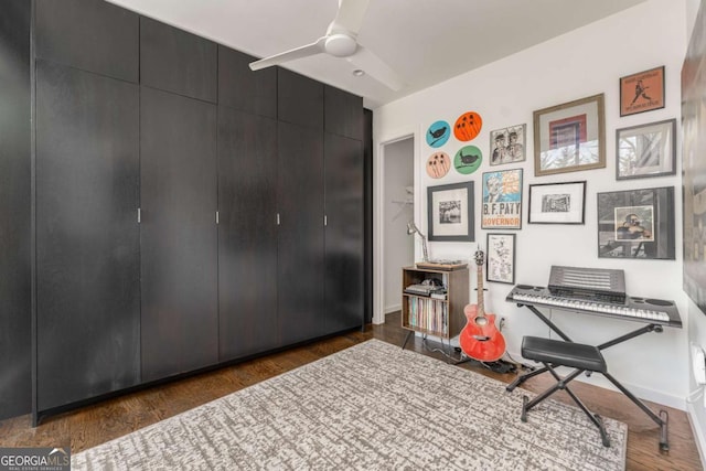 interior space with ceiling fan, baseboards, and wood finished floors