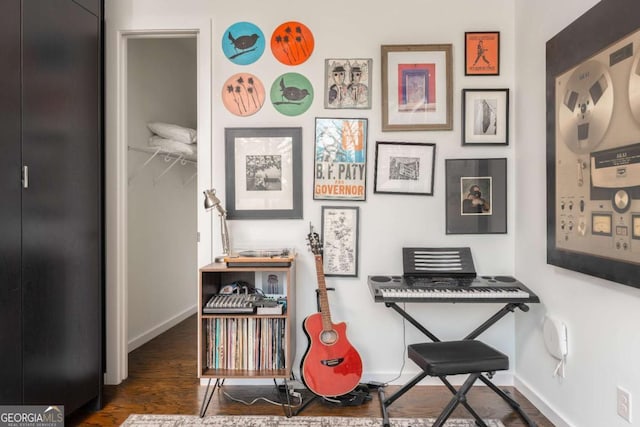 interior space featuring baseboards and wood finished floors