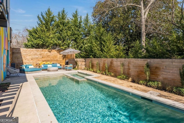 view of swimming pool featuring a patio area, outdoor lounge area, a fenced backyard, and a pool with connected hot tub