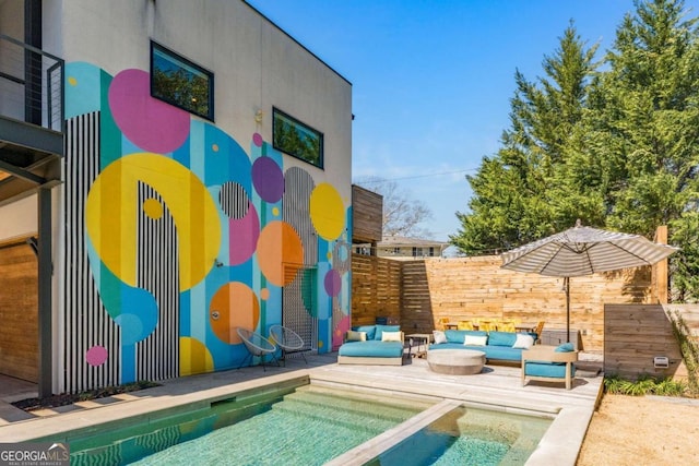 exterior space with a pool with connected hot tub, a patio area, an outdoor living space, and stucco siding