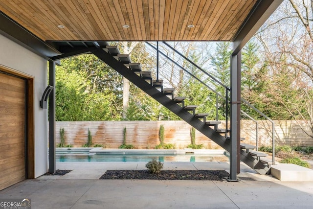 view of patio / terrace with a fenced backyard, stairs, and a fenced in pool