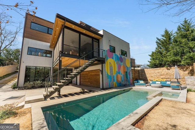 back of property featuring a fenced in pool, a patio, an outdoor hangout area, stairs, and fence