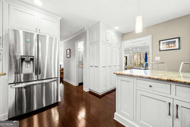 kitchen featuring light stone counters, dark wood finished floors, white cabinetry, and stainless steel fridge with ice dispenser