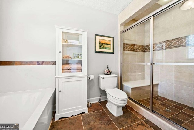 bathroom featuring a bath, a stall shower, a textured ceiling, and toilet