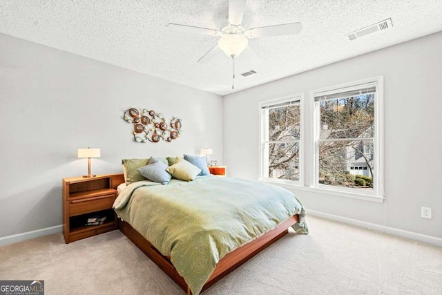 bedroom with light colored carpet, visible vents, and baseboards