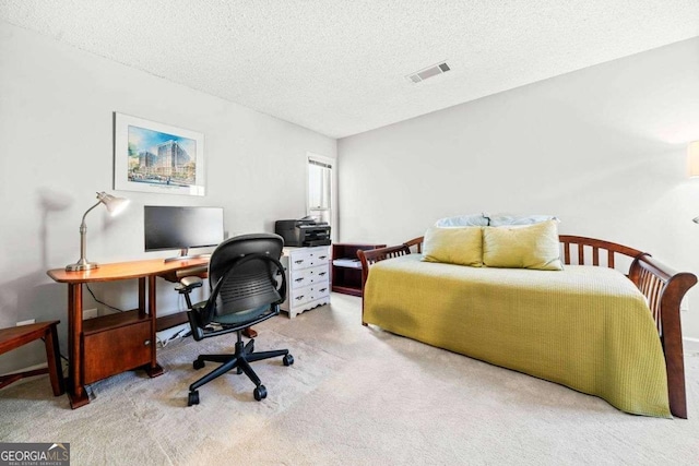 bedroom featuring a textured ceiling, carpet flooring, and visible vents