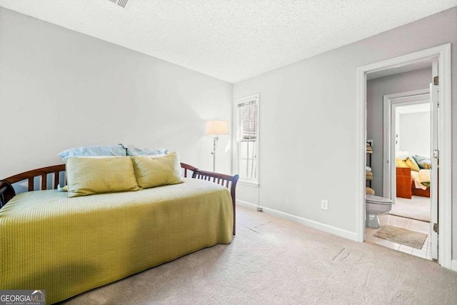 bedroom with carpet, a textured ceiling, and baseboards