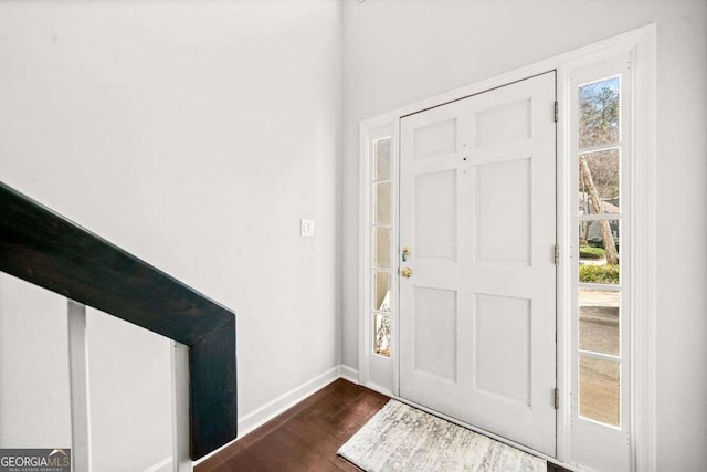 entrance foyer featuring dark wood finished floors and baseboards