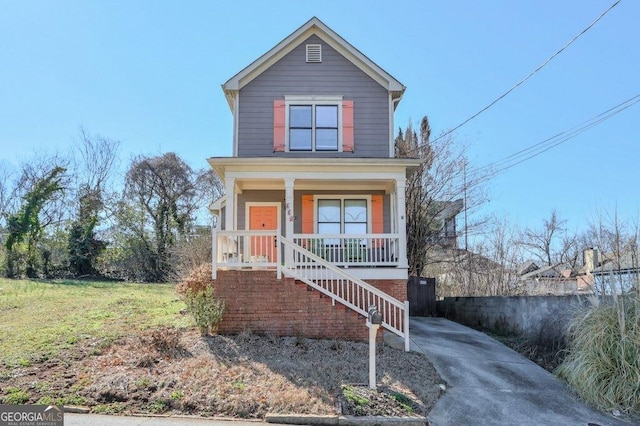 traditional-style house with a porch and stairway