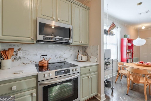 kitchen featuring tasteful backsplash, visible vents, ornamental molding, stainless steel appliances, and light countertops