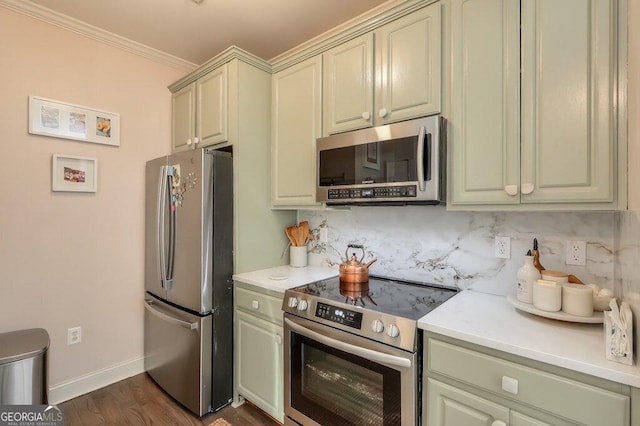 kitchen with stainless steel appliances, cream cabinetry, light countertops, and tasteful backsplash