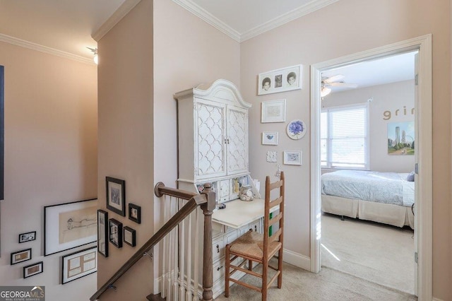 interior space with carpet floors, baseboards, ornamental molding, and an upstairs landing