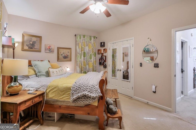 bedroom with baseboards, ceiling fan, and light colored carpet