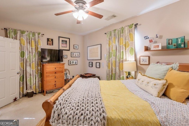 bedroom with a ceiling fan, visible vents, and carpet flooring