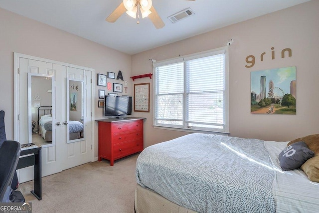 bedroom featuring ceiling fan, visible vents, french doors, and light colored carpet