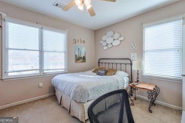 bedroom with light colored carpet, visible vents, and baseboards