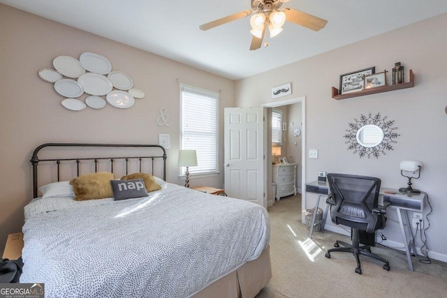 bedroom featuring a ceiling fan, light colored carpet, and baseboards