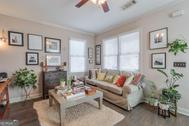 living area featuring visible vents, wood finished floors, a wealth of natural light, and ornamental molding