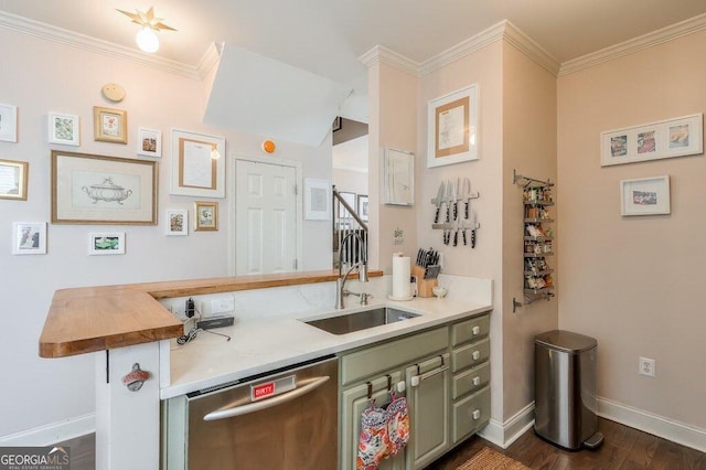 kitchen with a sink, ornamental molding, green cabinets, and stainless steel dishwasher