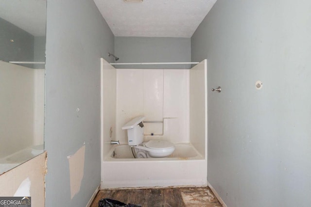 bathroom with bathtub / shower combination, baseboards, toilet, and wood finished floors