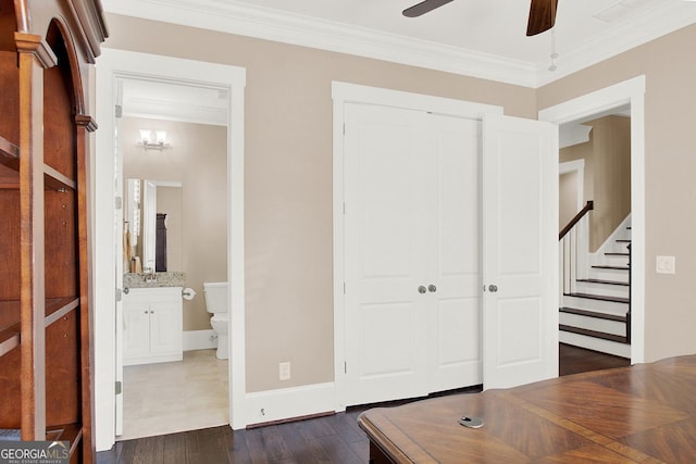 unfurnished office with ceiling fan, ornamental molding, dark wood-type flooring, and baseboards