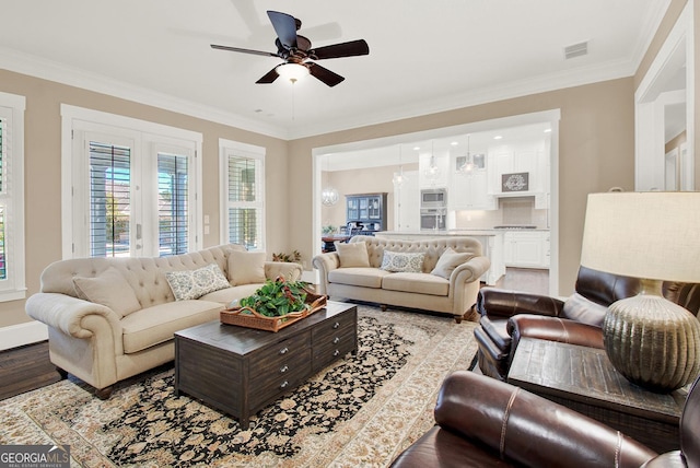 living area featuring crown molding and wood finished floors