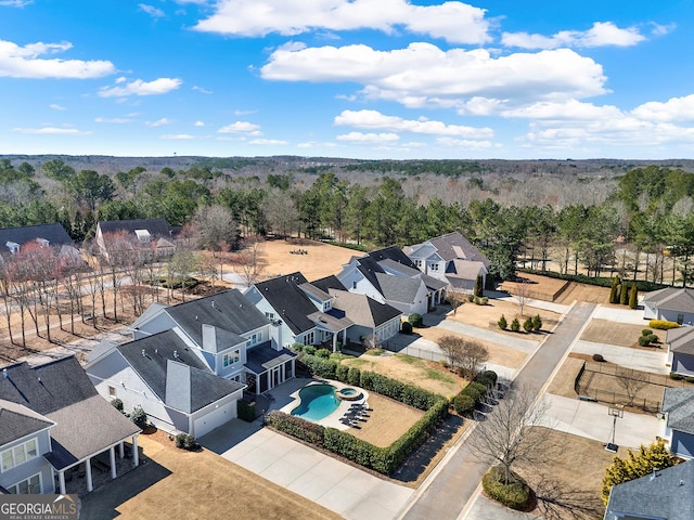 drone / aerial view with a forest view and a residential view