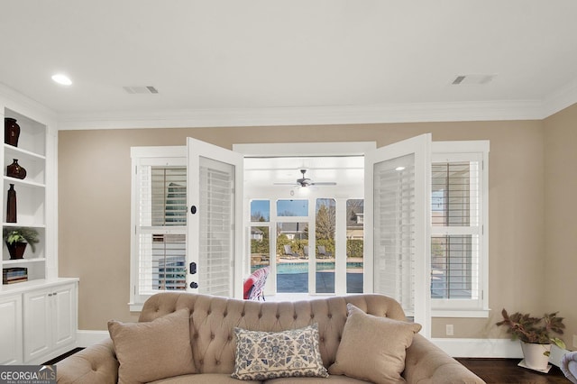 living room featuring crown molding, visible vents, baseboards, and dark wood-type flooring