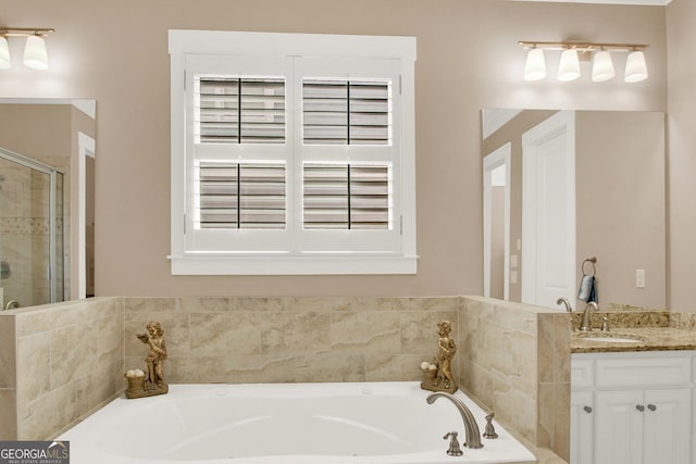 full bath featuring a stall shower, vanity, and a bath