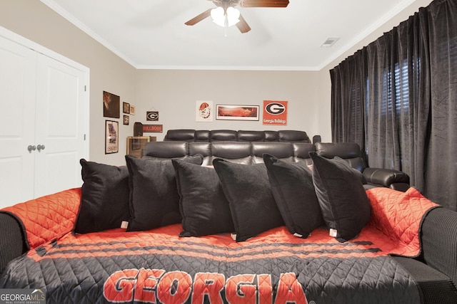 cinema featuring ornamental molding, visible vents, and ceiling fan