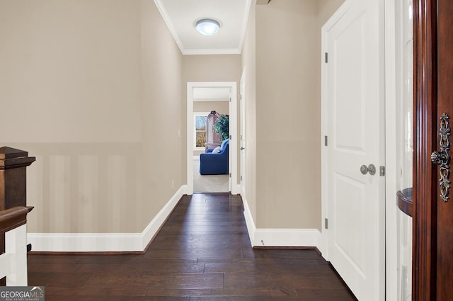 corridor with dark wood-style floors, baseboards, and crown molding