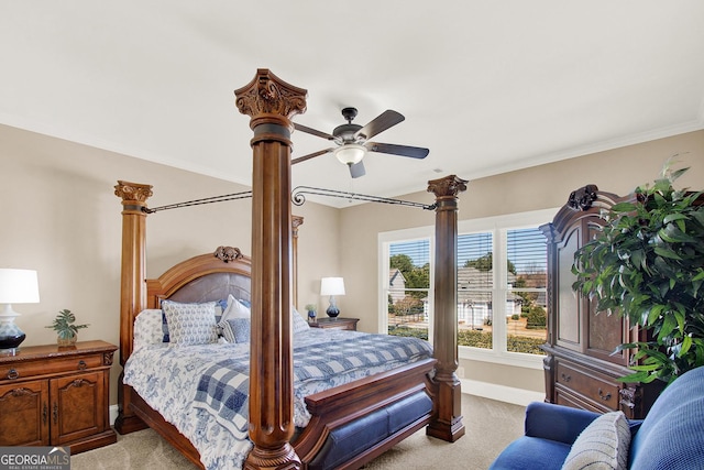 bedroom featuring light carpet, ceiling fan, crown molding, and baseboards