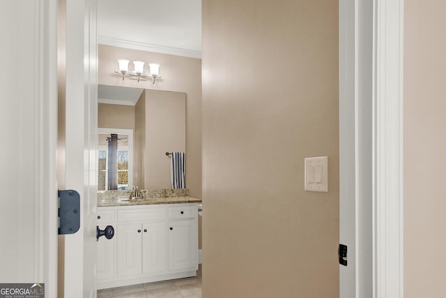 bathroom with crown molding and vanity