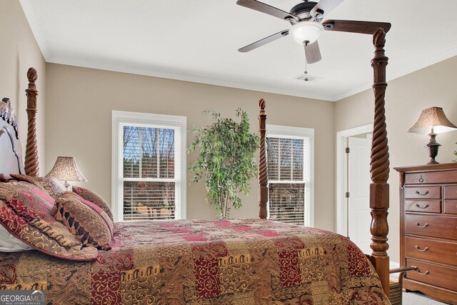 bedroom with ceiling fan, ornamental molding, and visible vents