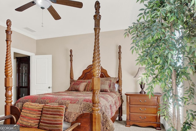 carpeted bedroom featuring visible vents, a ceiling fan, and ornamental molding