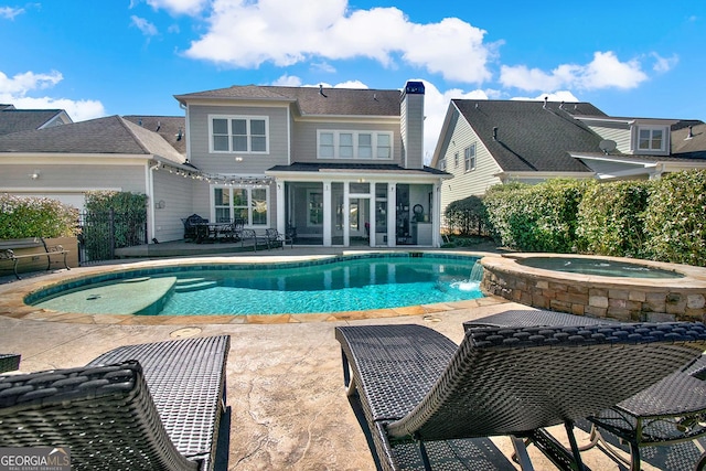 view of pool featuring a pool with connected hot tub and a patio