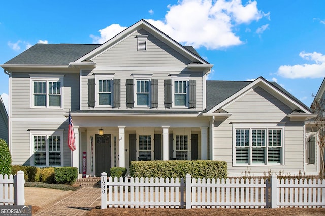 view of front of home with a porch and a fenced front yard