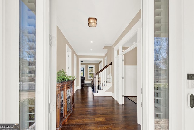 entrance foyer featuring baseboards, wood finished floors, stairs, crown molding, and recessed lighting