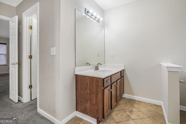 bathroom featuring tile patterned flooring, vanity, and baseboards