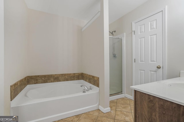 full bathroom with a shower stall, vanity, a bath, and tile patterned floors