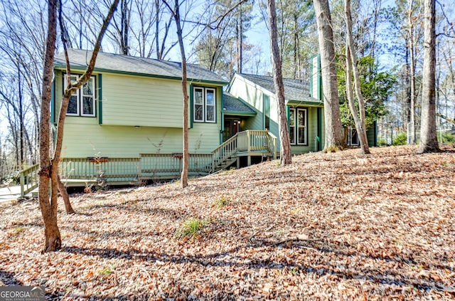 back of property with a wooden deck