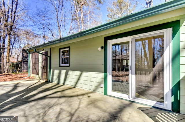 view of exterior entry featuring fence