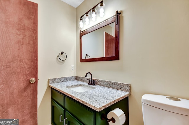 half bathroom featuring toilet and vanity