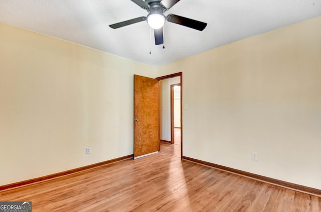 empty room with light wood finished floors and baseboards